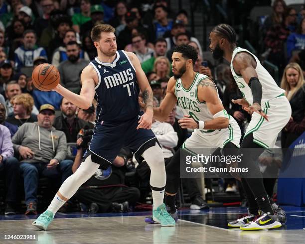 Jayson Tatum and Jaylen Brown of the Boston Celtics guard Luka Doncic of the Dallas Mavericks during the game between the Boston Celtics and the...