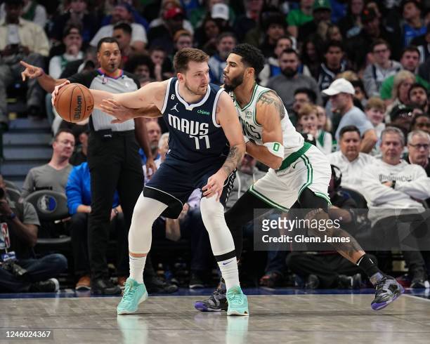 Jayson Tatum of the Boston Celtics guards Luka Doncic of the Dallas Mavericks during the game between the Boston Celtics and the Dallas Mavericks on...