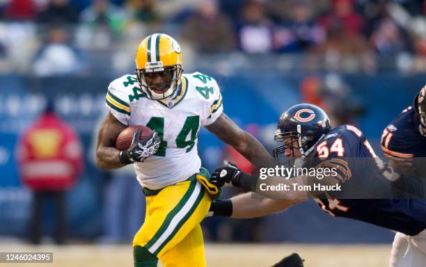 James Starks of the Green Bay Packers runs past Brian Urlacher of the Chicago Bears in the NFC Championship Game at Soldier Field on January 23, 2011...