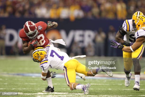 Eddie Lacy of the Alabama Crimson Tide is tackled by Tyrann Mathieu of the Louisiana State University Tigers in the 2012 Allstate BCS National...