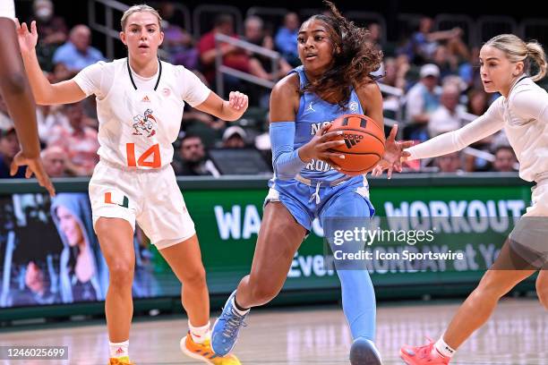 North Carolina guard Deja Kelly attempts to drives to the basket between Miami guard Haley Cavinder and guard Hanna Cavinder in the second quarter as...