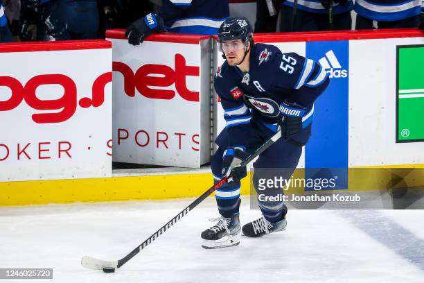 Mark Scheifele of the Winnipeg Jets plays the puck during third period action against the Vancouver Canucks at Canada Life Centre on December 29,...