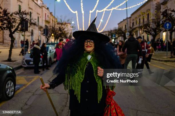 The Befana in front of the procession made up of adults and children parade with the Befana stocking, 50 meters long, through the streets of the city...