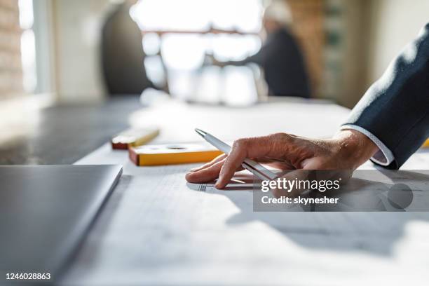 close up of examining home design at construction site. - rebuilding stock pictures, royalty-free photos & images