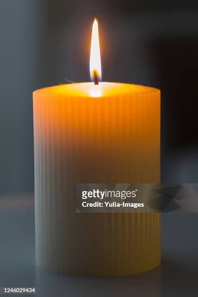 large cylindrical burning white candle - mourning candles stock pictures, royalty-free photos & images