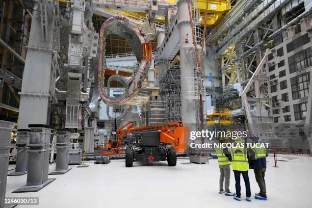 People talk near a module being assembled at the international nuclear fusion project Iter in Saint-Paul-les-Durance, southern France, on January 5,...