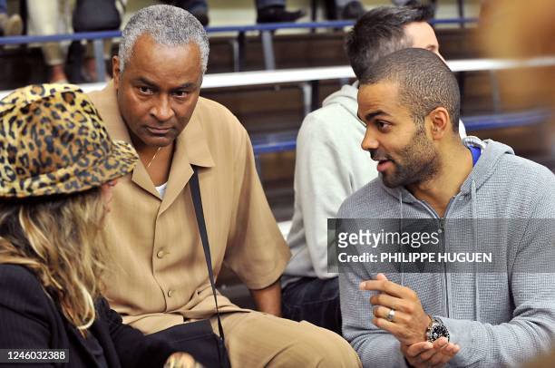 French NBA player Tony Parker speaks with his parents before attending the French basket-ball match BC Orchies vs Get Vosges on September 25, 2010 in...