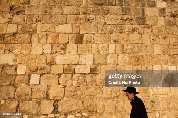 Person walks near the Old City wall in Jerusalem, Israel on December 29, 2022.