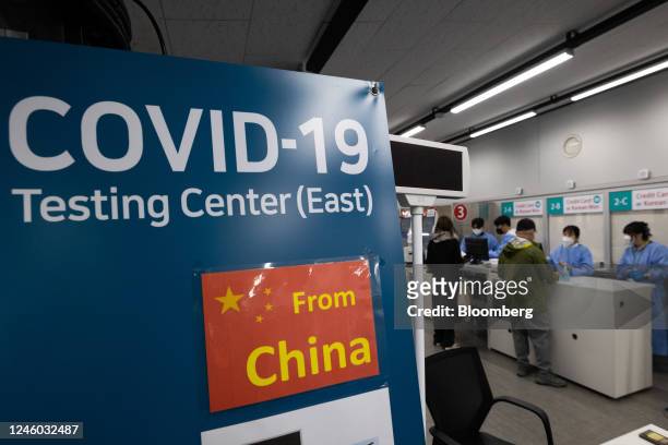 Signage for travelers arriving from China posted at a Covid-19 testing center at Incheon International Airport in Incheon, South Korea, on Friday,...