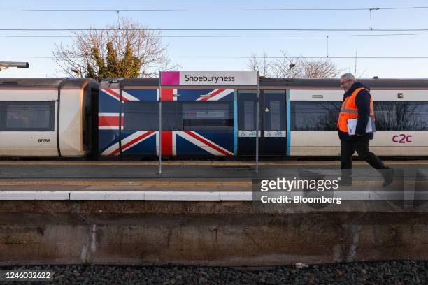 Worker passes a train carriage featuring a British Union flag livery at Shoeburyness railway Station, during strike action by the National Union of...