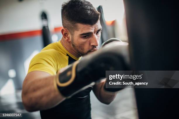 man boxer training alone in gym - boxing young men stock pictures, royalty-free photos & images