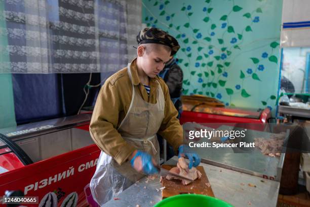 Volunteers with Myrne Nebo prepare meals for residents at a closed school in the town of Kupiansk which has experienced regular shelling from the...