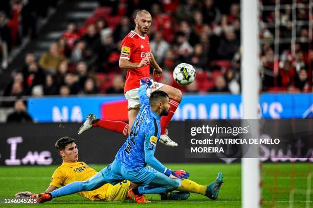 Benfica's Norwegian midfielder Fredrik Aursnes vies with Portimonense's Portuguese defender Filipe Relvas and Portimonense's Japonese goalkeeper...