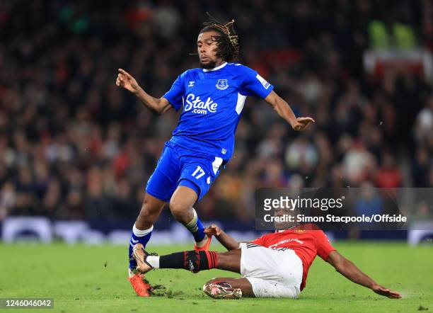 Tyrell Malacia of Manchester United takes out the standing leg of Alex Iwobi of Everton during the Emirates FA Cup Third Round match between...