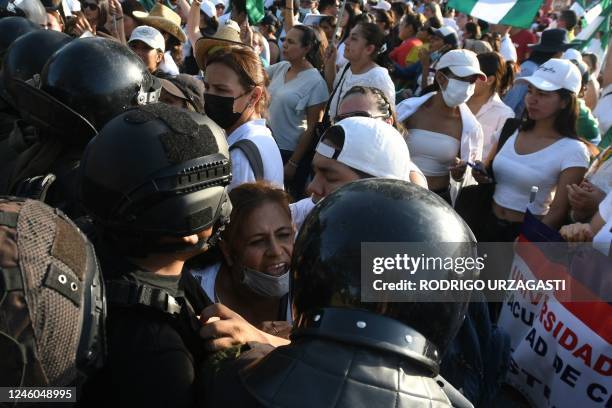 Woman struggles with the police during a demonstration called by the Gabriel René Moreno Autonomous University demanding the liberation of Santa...