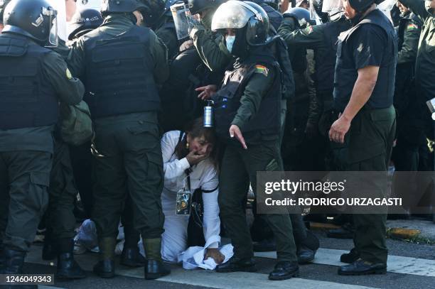 Woman struggles with the police during a demonstration called by the Gabriel René Moreno Autonomous University demanding the liberation of Santa...