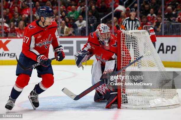 Charlie Lindgren and Trevor van Riemsdyk of the Washington Capitals watch the play behind the net during a game against the Nashville Predators at...