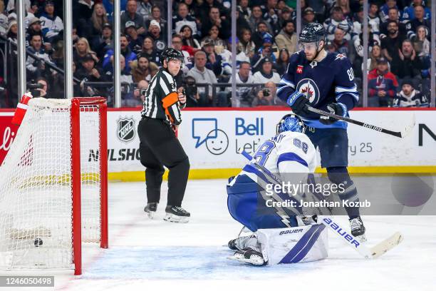 Pierre-Luc Dubois of the Winnipeg Jets watches as the puck goes into the net behind goaltender Andrei Vasilevskiy of the Tampa Bay Lightning for a...