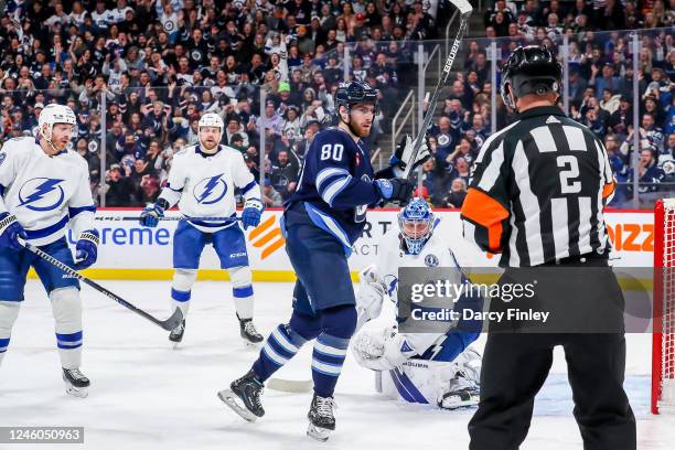 Pierre-Luc Dubois of the Winnipeg Jets raises his stick in celebration after scoring a second period goal against the Tampa Bay Lightning at the...