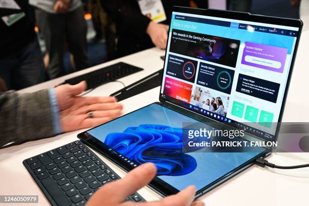 The new Lenovo dual-screen Yoga Book 9i laptop is demonstrated with different screen and keyboard modes at the Microsoft Inc. Booth during the...