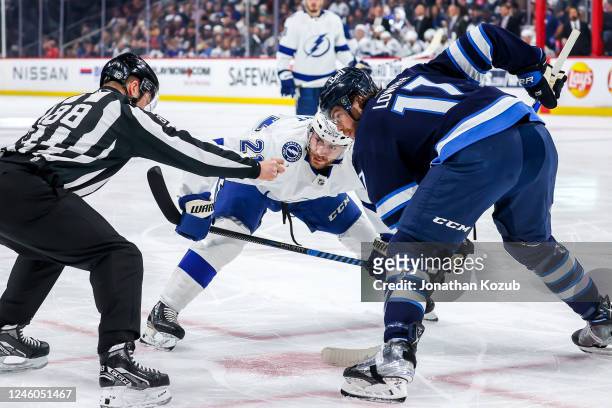 Brayden Point of the Tampa Bay Lightning gets set for a first period face-off against Adam Lowry of the Winnipeg Jets at the Canada Life Centre on...