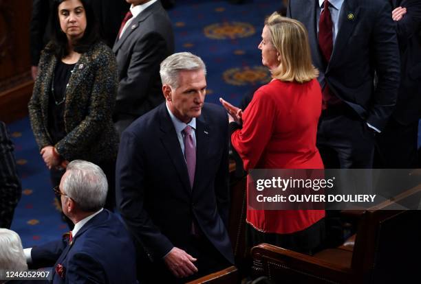 Representative Kevin McCarthy returns to his seat after speaking to US Representative Matt Gaetz , not pictured, in the House Chamber as voting...