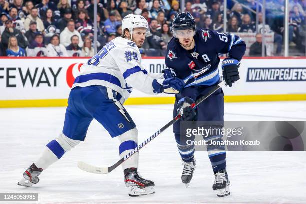 Mikhail Sergachev of the Tampa Bay Lightning and Mark Scheifele of the Winnipeg Jets battle as they keep an eye on the play during second period...