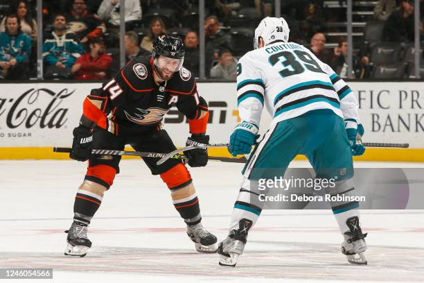 Adam Henrique of the Anaheim Ducks and Logan Couture of the San Jose Sharks get ready for the face off during the third period at Honda Center on...