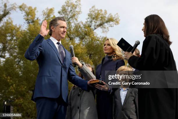 Gov. Gavin Newsom, shown with wife Jennifer Lynn Siebel Newsom and children; Brooklynn and Dutch, takes the oath of office sworn in by Chief Justice...