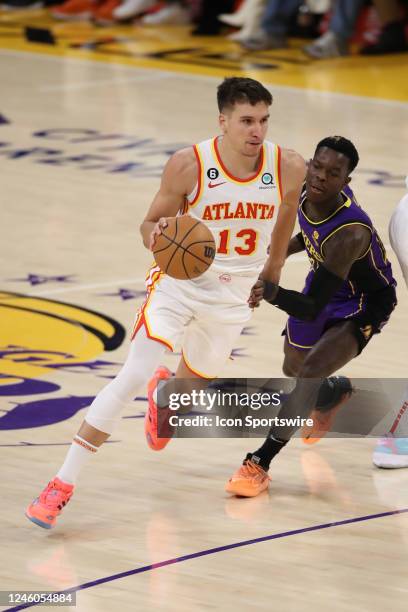 Atlanta Hawks guard Bogdan Bogdanovic goes by Los Angeles Lakers guard Dennis Schroder during the NBA game between the Atlanta Hawks and the Los...