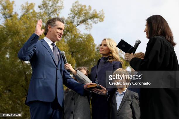 Gov. Gavin Newsom, shown with wife Jennifer Lynn Siebel Newsom and children; Brooklynn and Dutch, takes the oath of office sworn in by Chief Justice...