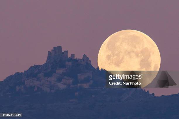 Wolf moon sets behind Rocca Calascio castle and village in Calascio, Italy, on January 7, 2023. The first full moon of the year is often called the...