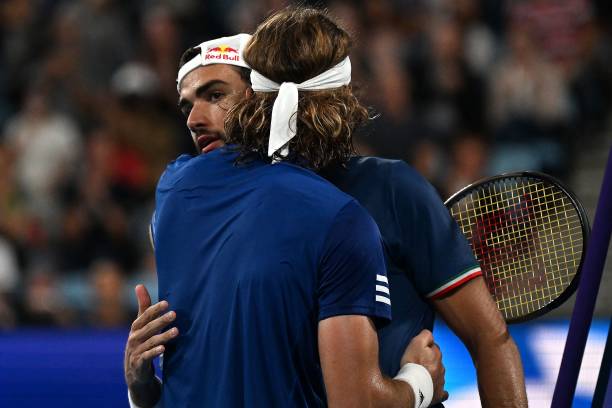 Greeces Stefanos Tsitsipas embraces Italys Matteo Berrettini after their mens singles in the semi-final of the United Cup tennis tournament in Sydney...