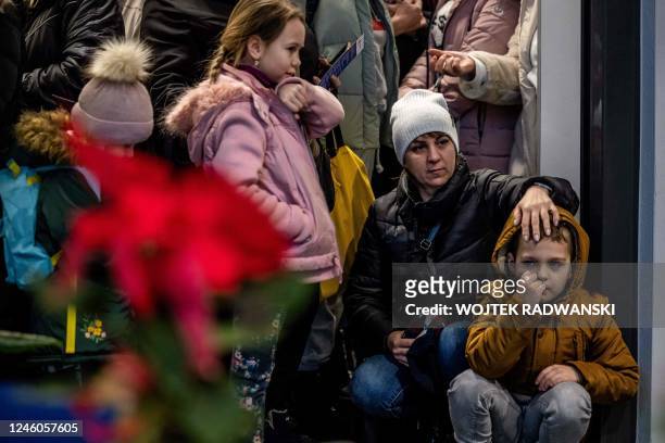 Svitlana Borysova and her children are seen waiting for the start of the Christmas supper for Ukraininan refugees staying in Warsaw on Orthodox...