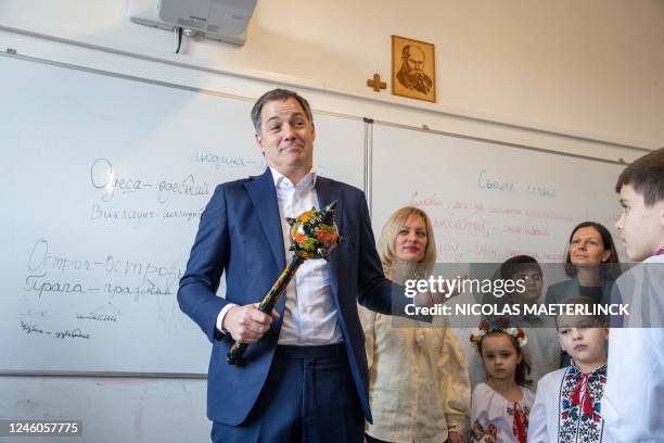 Prime Minister Alexander De Croo holds a scepter with floral decoration during a visit of Belgian Prime Minister De Croo to a Ukrainian school on the...