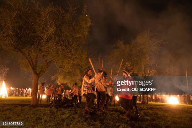Members of the Leominster Morris take part in a Twelfth Night wassailing ceremony around an apple tree in an orchard at Home Farm in Eardisland near...