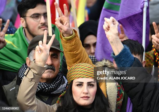 Demonstrators make V signs during a tribute march in the memory of the three Kurdish activists who were murdered in January 2013, in Paris, on...