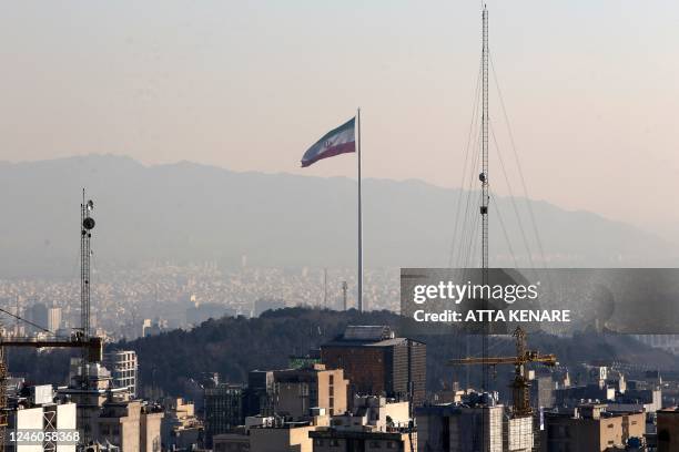 General view shows the Iranian capital Tehran on January 7 with the Iranian flag fluttering in the wind.