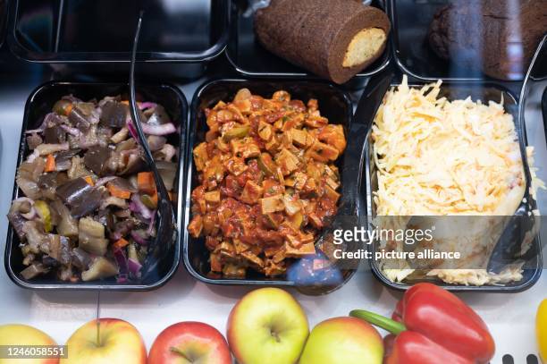January 2023, Saxony, Dresden: Salads made from eggplant , seitan and cabbage are on display at a vegan butcher shop's new opening. The vegan...