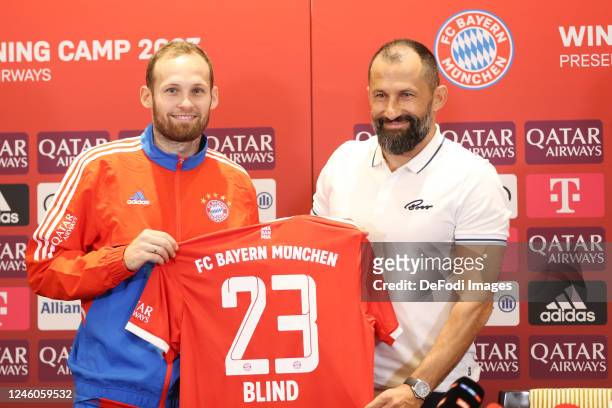 Daley Blind of Bayern Muenchen and chief of sport Hasan Salihamidzic of Bayern Muenchen show the Bayern Munchen kit to media during the Press...
