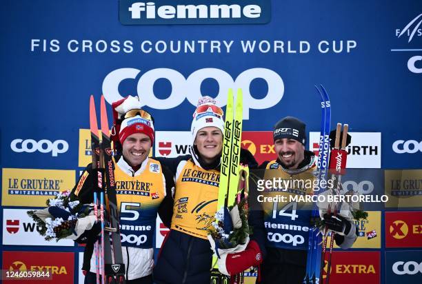 Second-placed Norway's Pal Golberg, race winner Norway's Johannes Hosflot Klaebo and third-placed Italy's Francesco De Fabiani pose after competing...