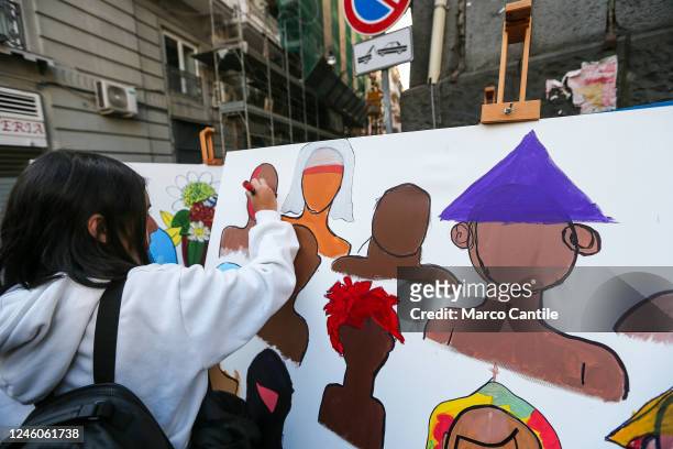 Woman paints a placard, during the protest and solidarity rally with the Iranian people "Women Life Freedom", against oppression and discrimination...