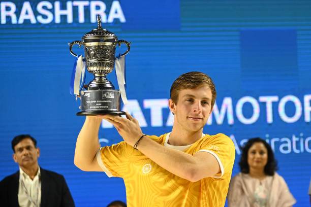 Netherlands' Tallon Griekspoor lifts the trophy after winning the Tata Open men's single final against France's Benjamin Bonzi at Balewadi Stadium in...