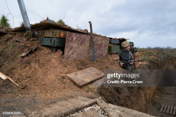 Ukrainian soldier stands guard in a trench as the Territorial Defense of Kherson reinforce their positions on January 7, 2023 in Kherson, Ukraine....