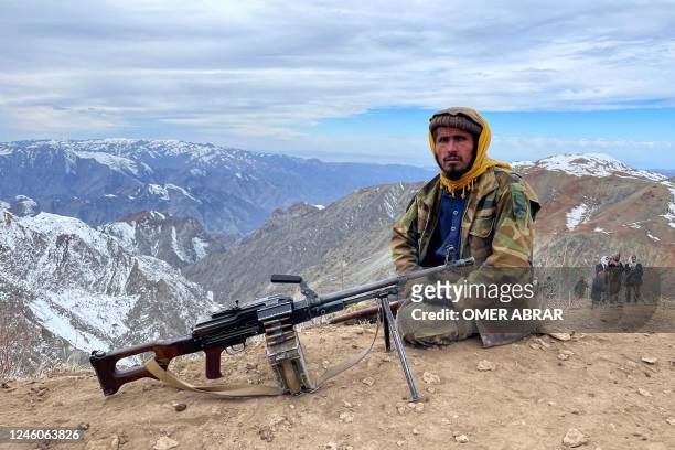 Taliban security personnel sits on a hill top during rescue operations for miners trapped after a gold mine collapsed in Yawan District of Badakhshan...