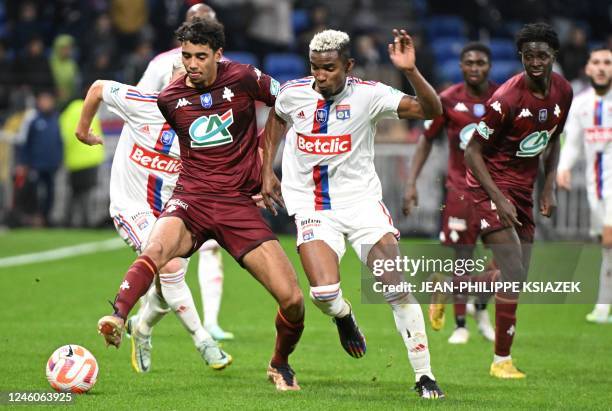 Metzs French midfielder Arthur Atta fights for the ball with Lyons Brazilian midfielder Thiago Mendes during the French Cup round of 64 football...