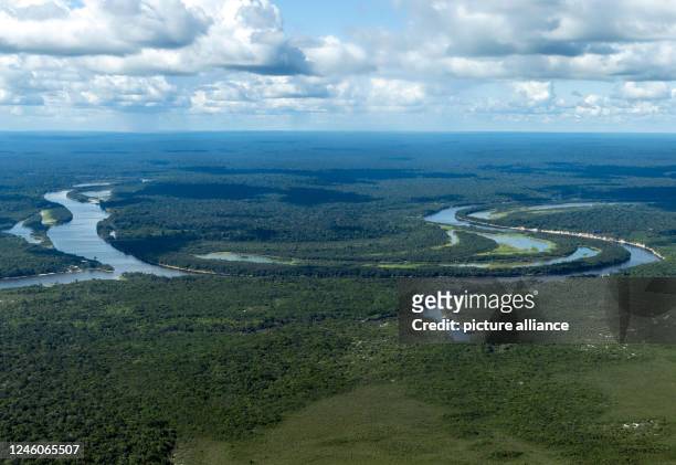 January 2023, Brazil, Manaus: A river meanders through the Amazon rainforest. The world's largest tropical rainforest is crisscrossed by thousands of...