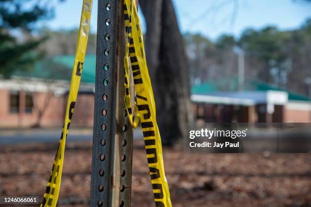 Police tape hangs from a sign post outside Richneck Elementary School following a shooting on January 7, 2023 in Newport News, Virginia. A 6-year-old...