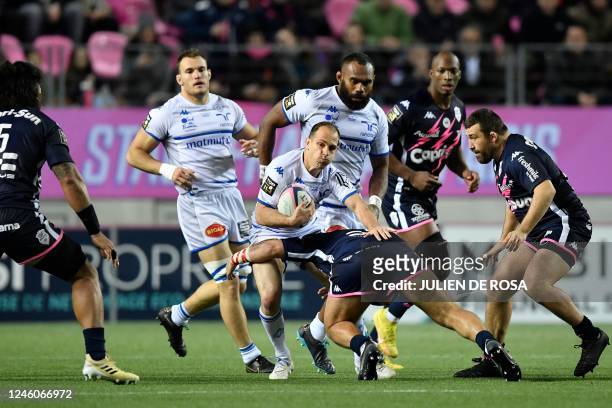 Castres' Argentinian fly-half Benjamin Urdapilleta is tackled during the French Top 14 rugby union match between Stade Francais Paris and Castres...