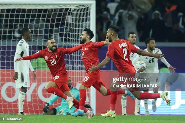 Bahrain's forward Kamil al-Aswad celebrates with teammates after scoring their opening goal during the Arabian Gulf Cup football match between...